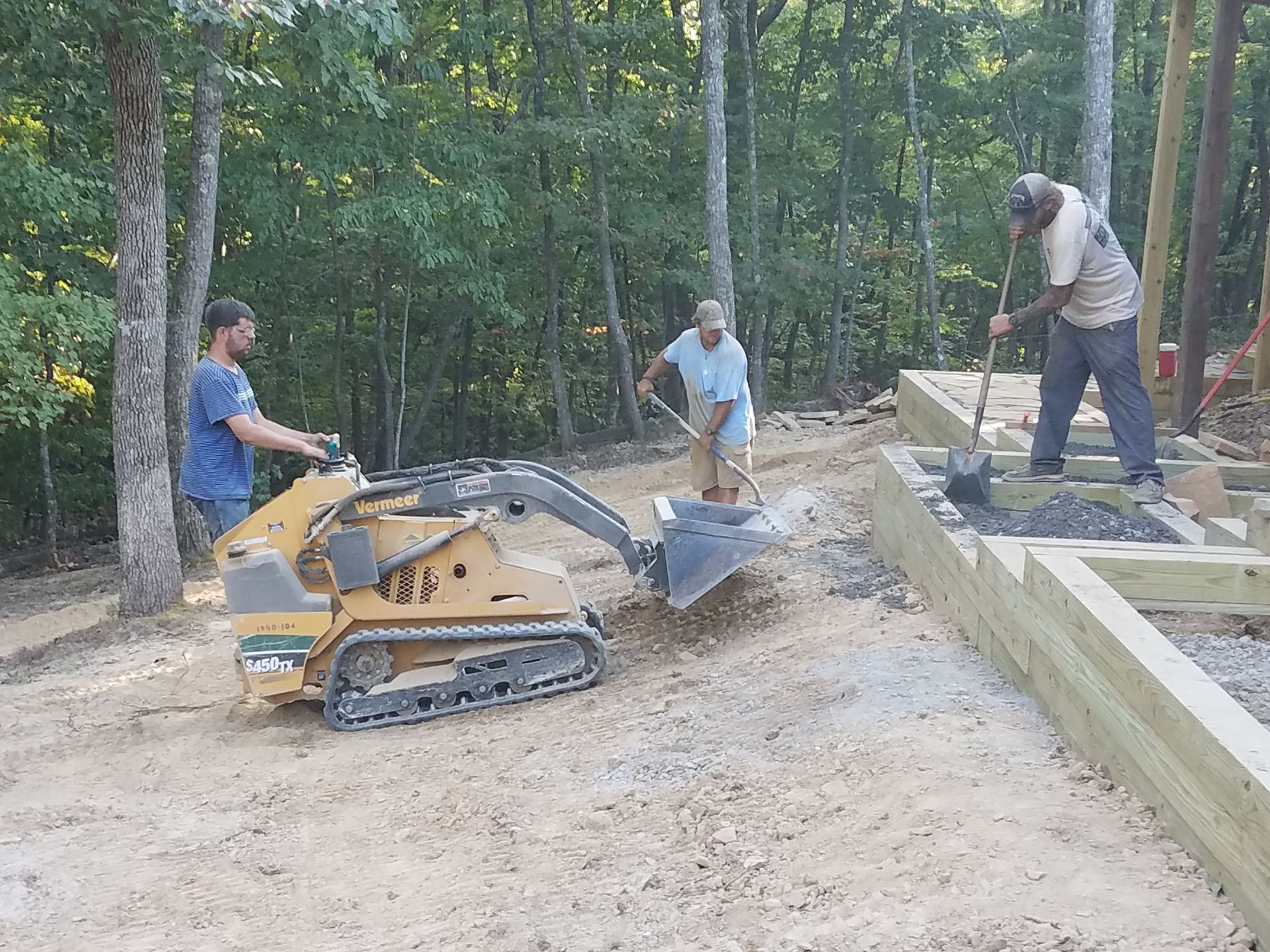 A group of men are working on a lawn project.