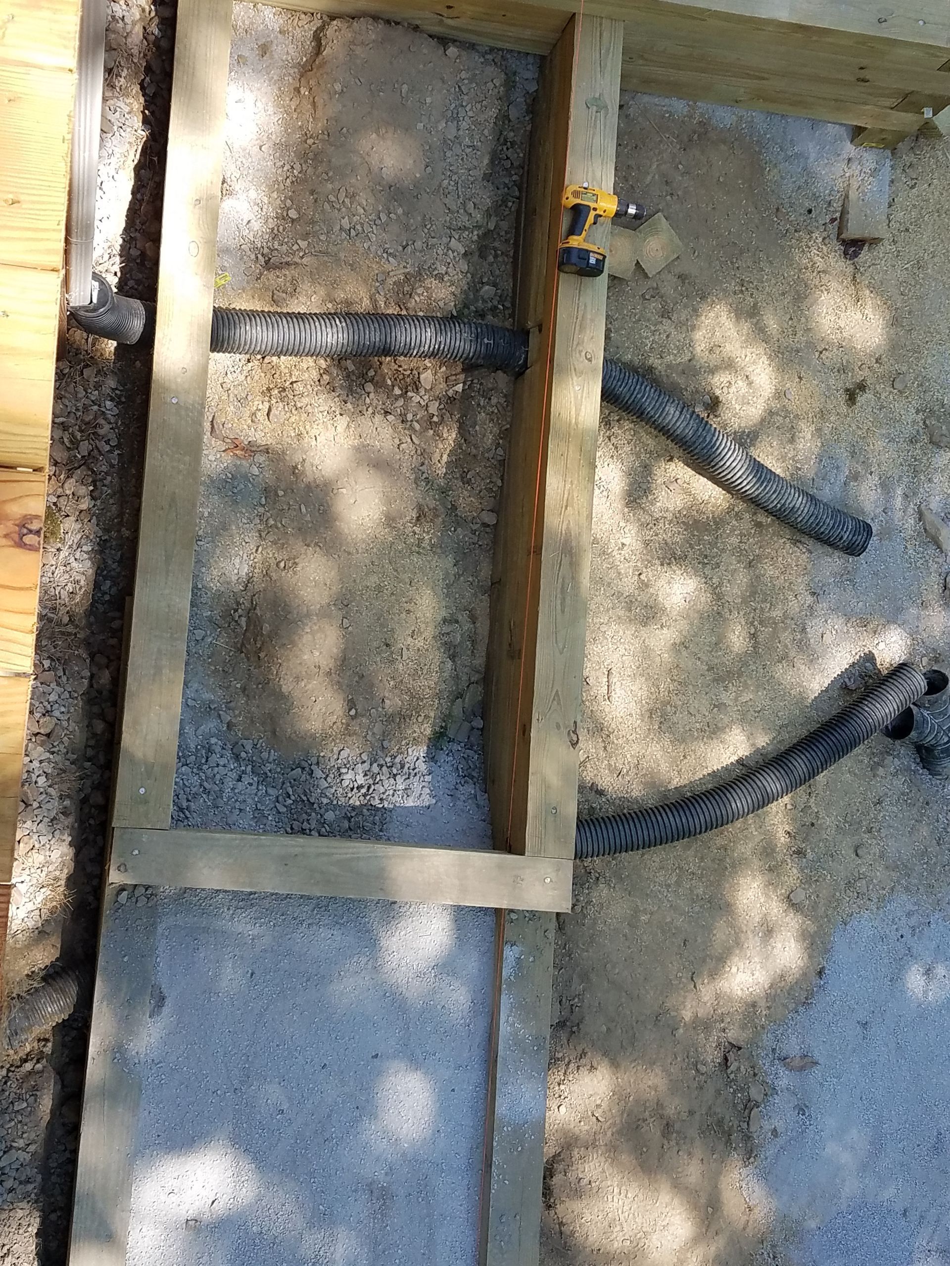 A wooden frame is sitting on top of a concrete surface.