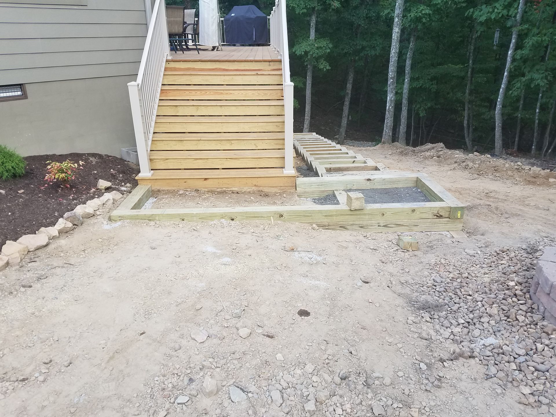 A wooden deck with stairs leading up to it
