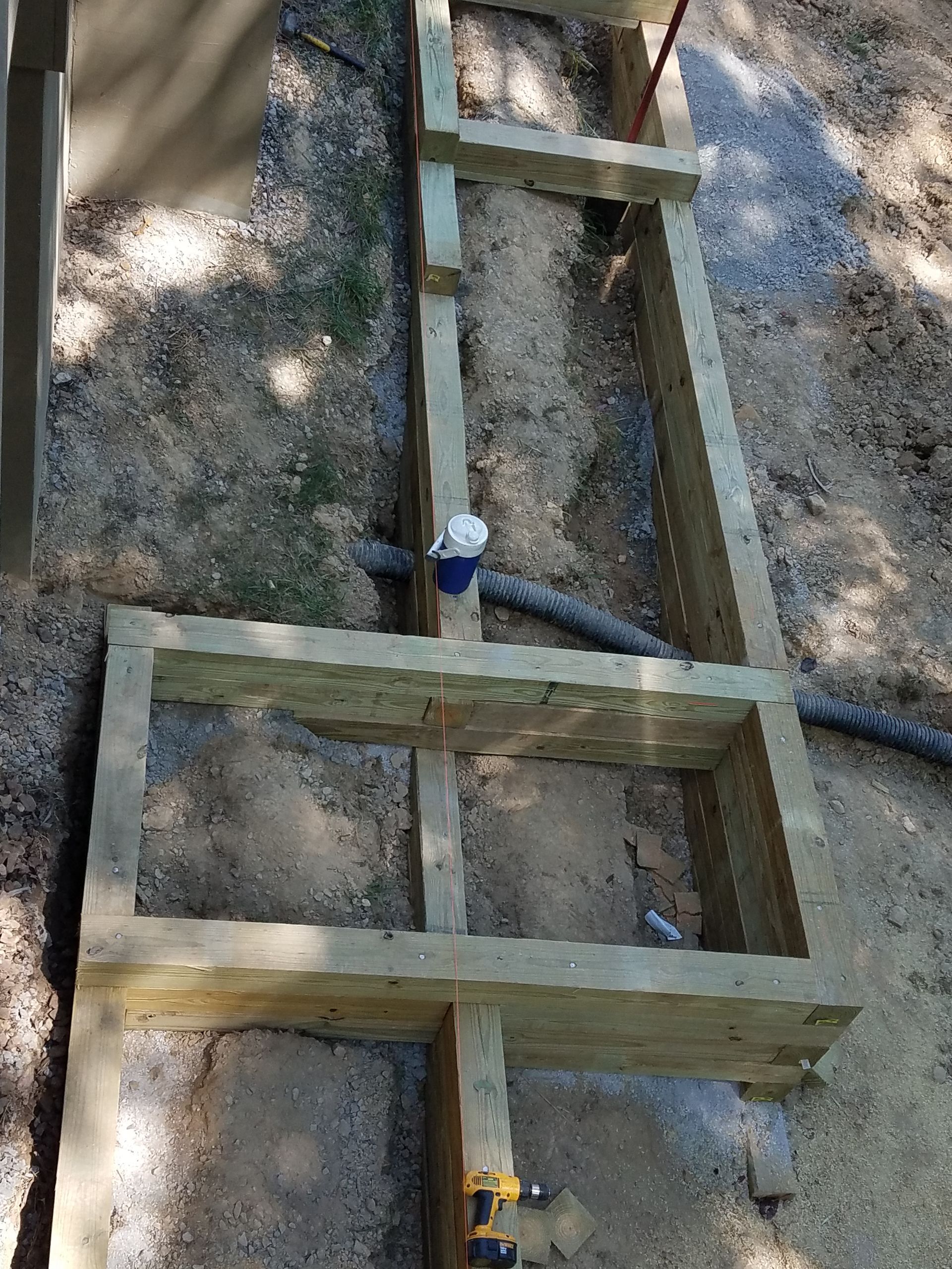 A wooden structure is being built in the dirt.