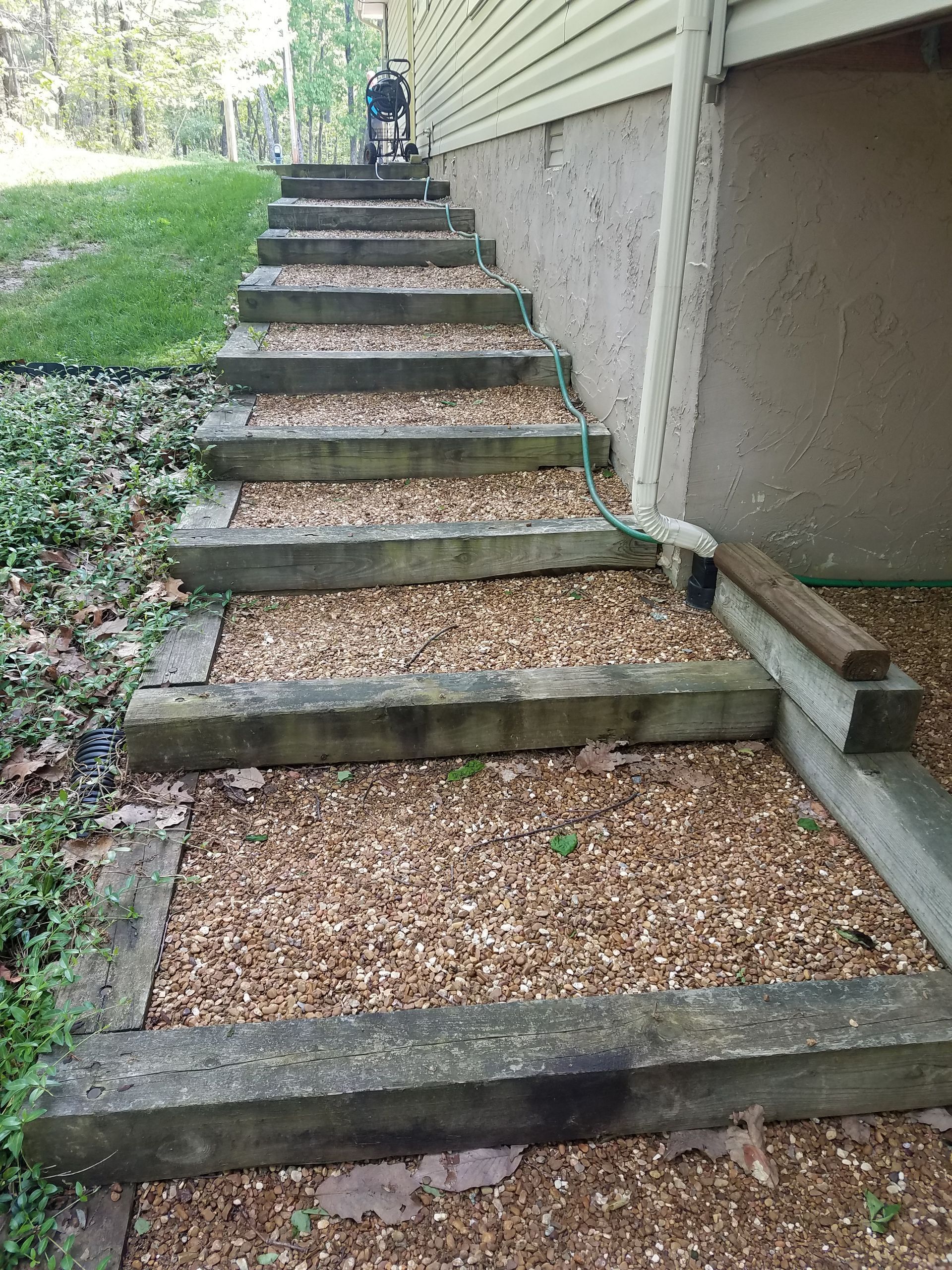 A set of wooden stairs leading up to a house.