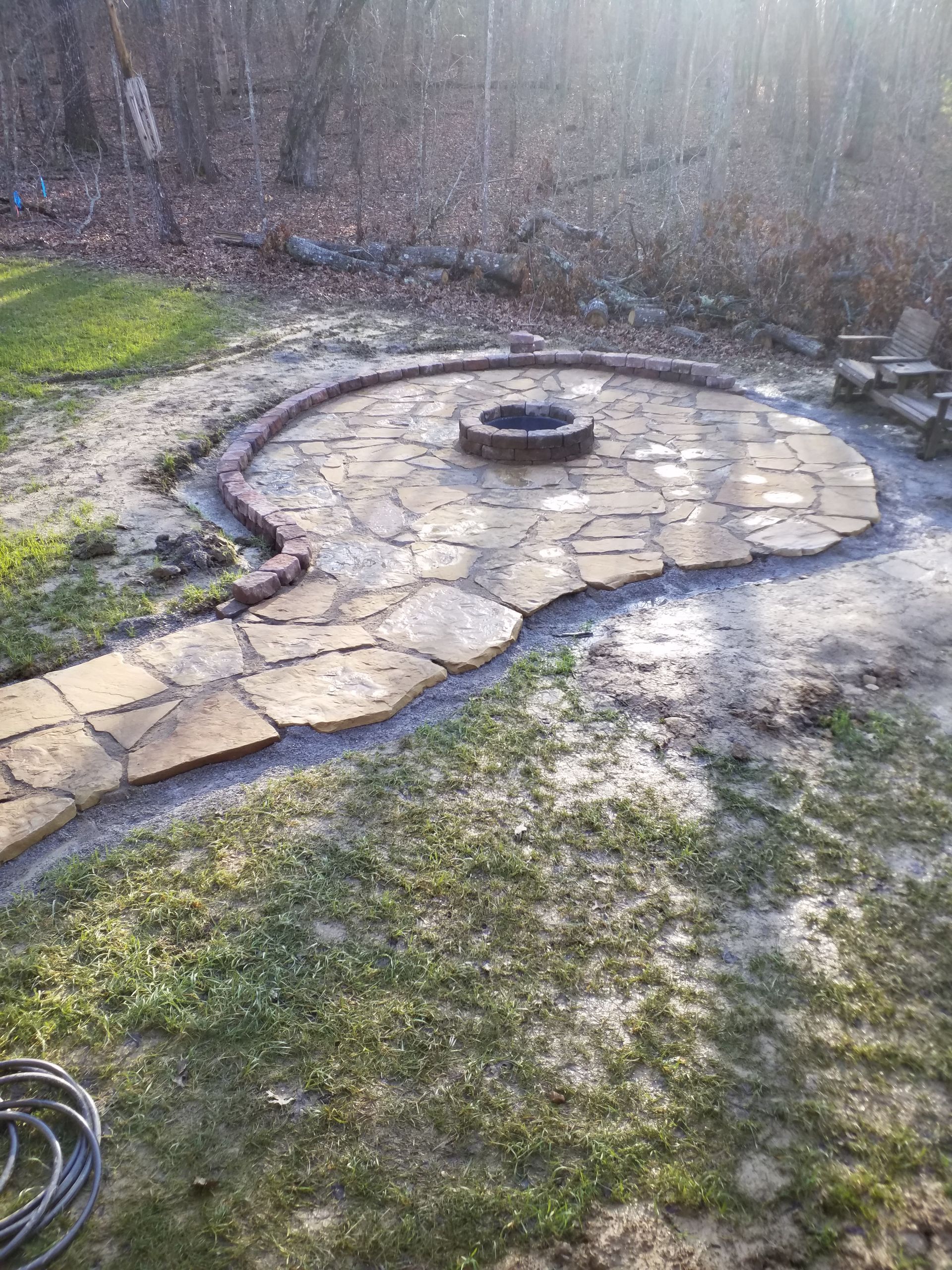 There is a fire pit in the middle of the patio.