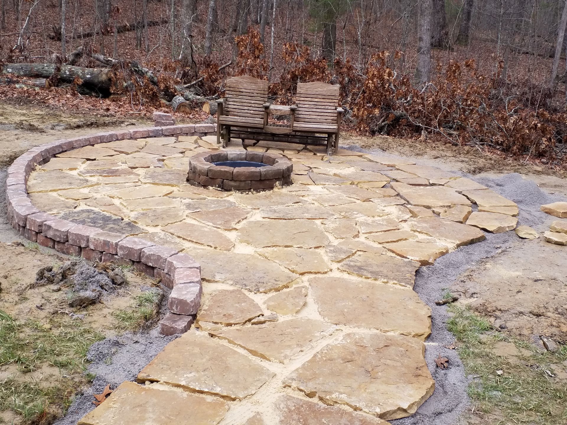 There is a fire pit in the middle of the patio.