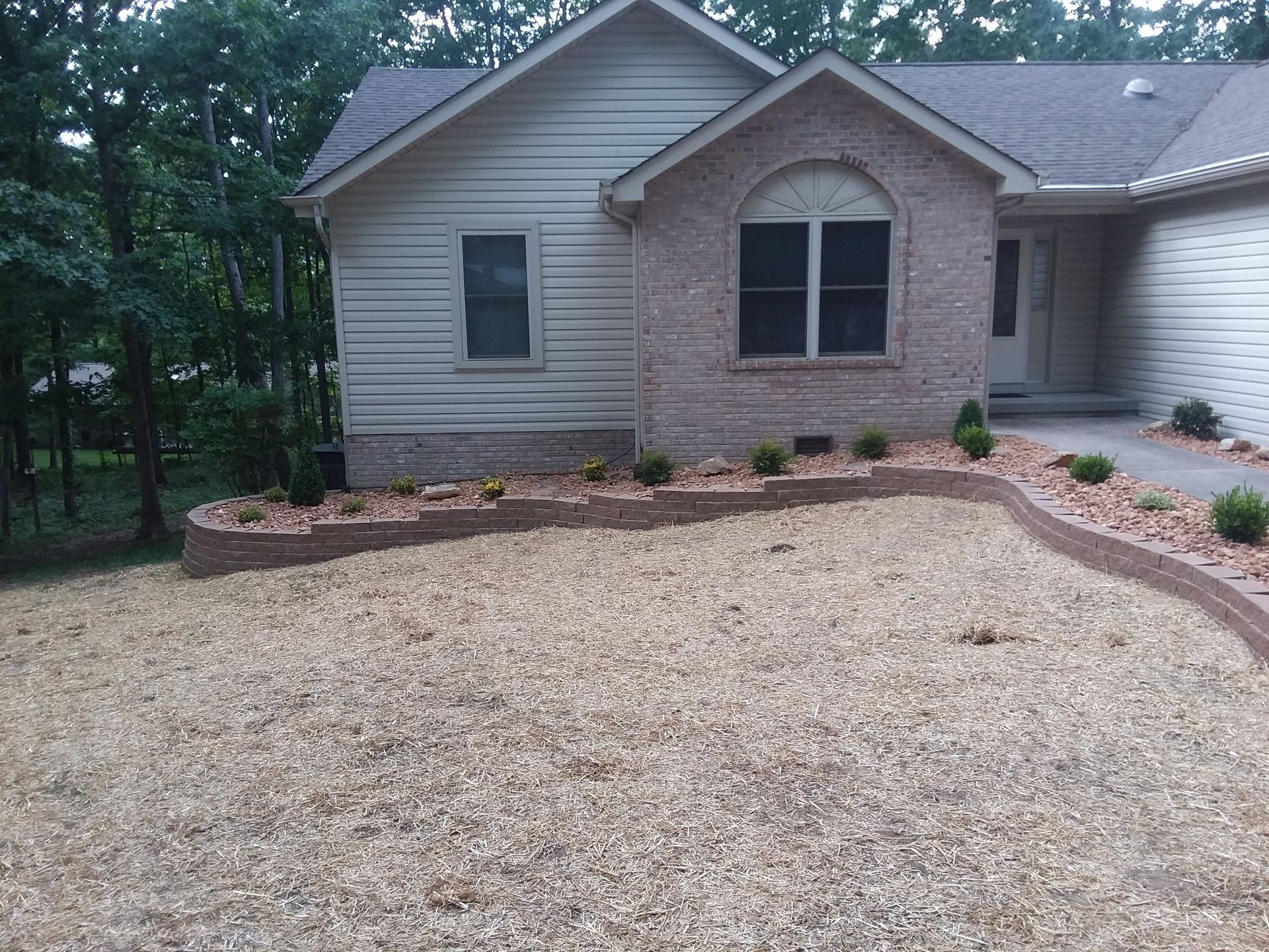 A house with a gravel driveway in front of it