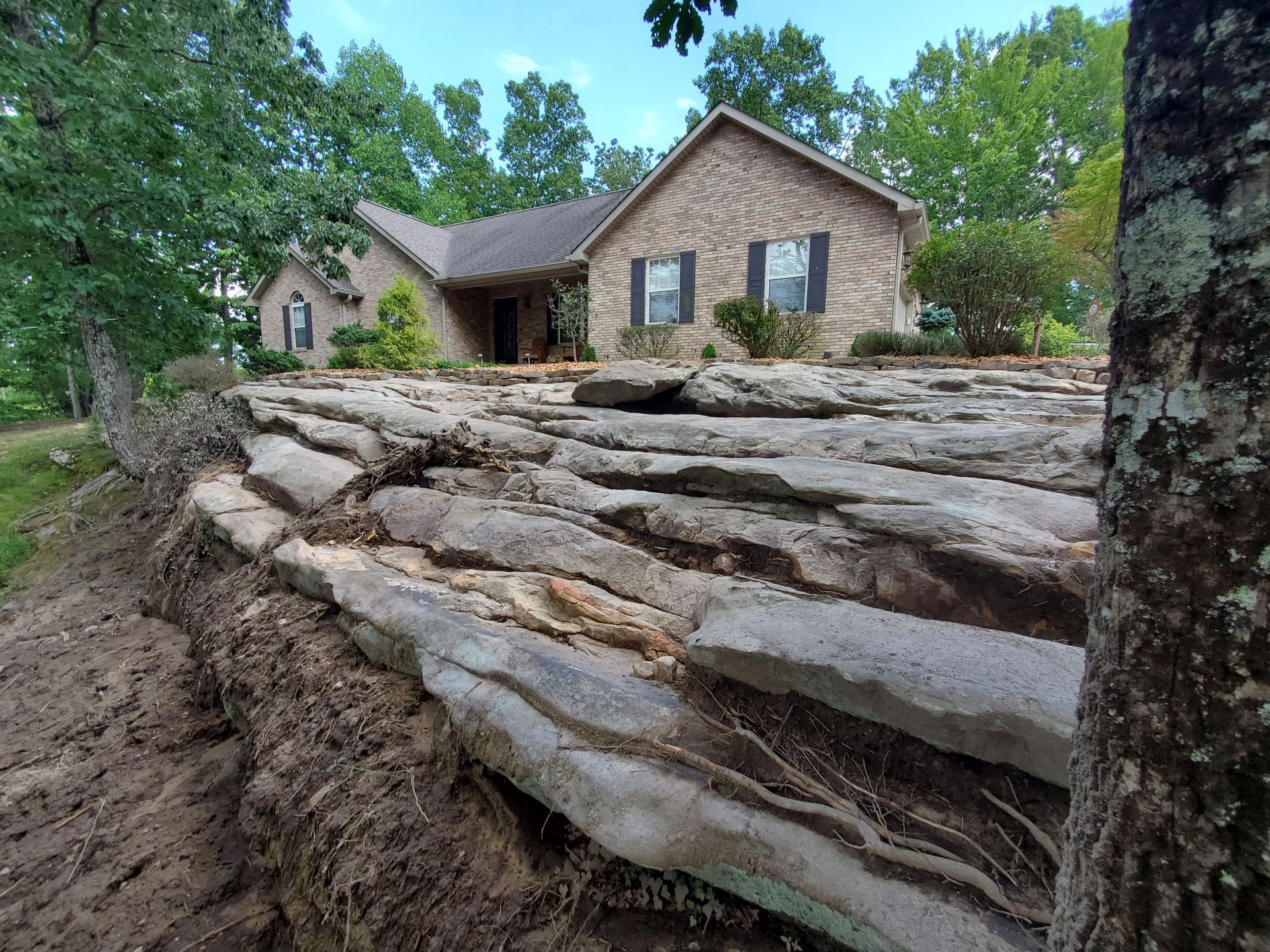 A brick house with a stone walkway in front of it.