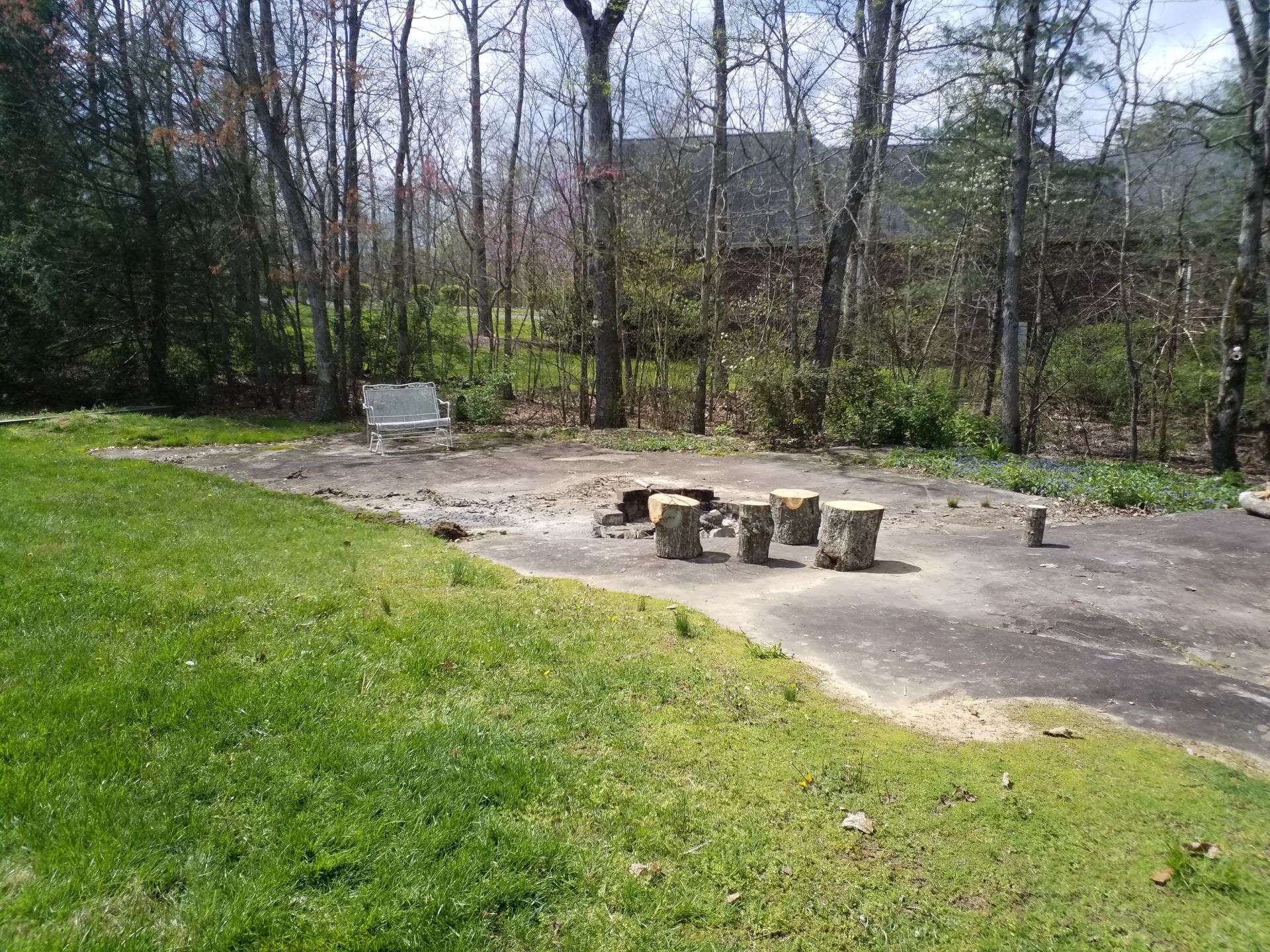 There is a fire pit in the middle of a grassy field.