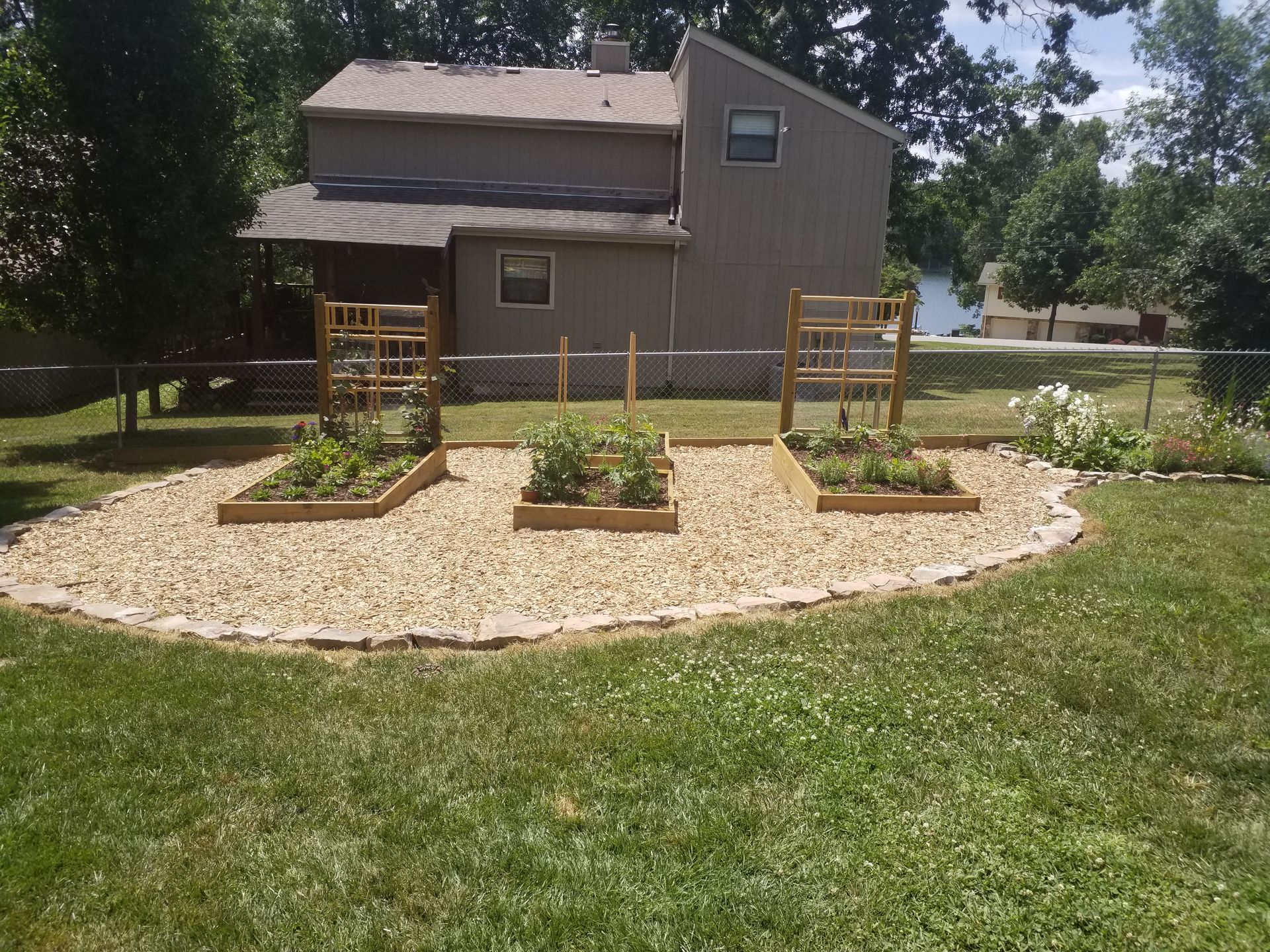 A house with a fence and a garden in front of it