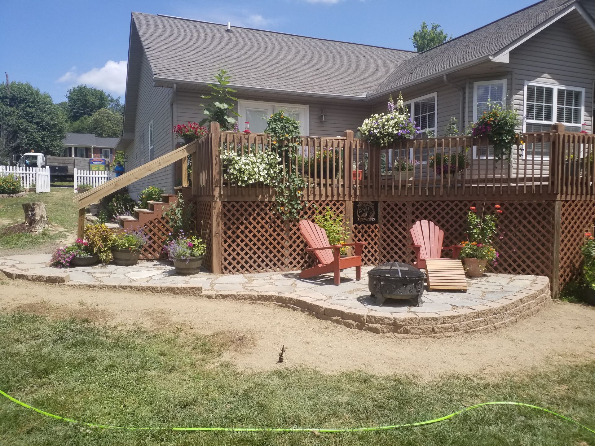 A house with a deck and chairs in front of it