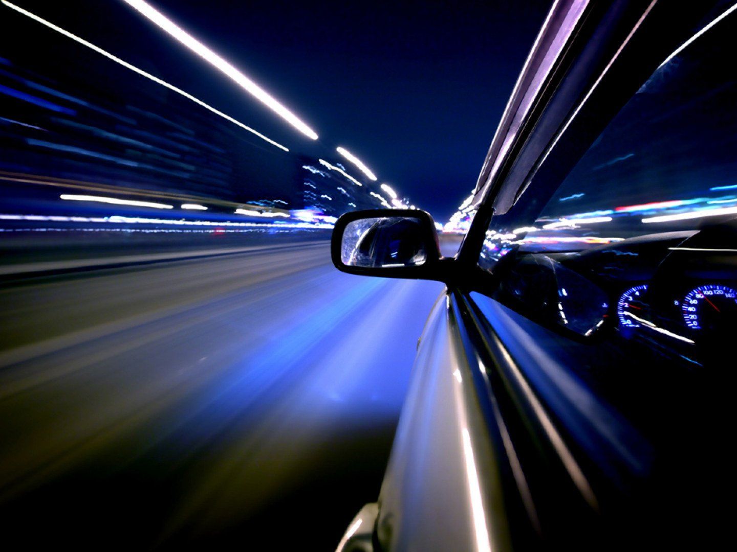A high-end automobile is driving down the road
