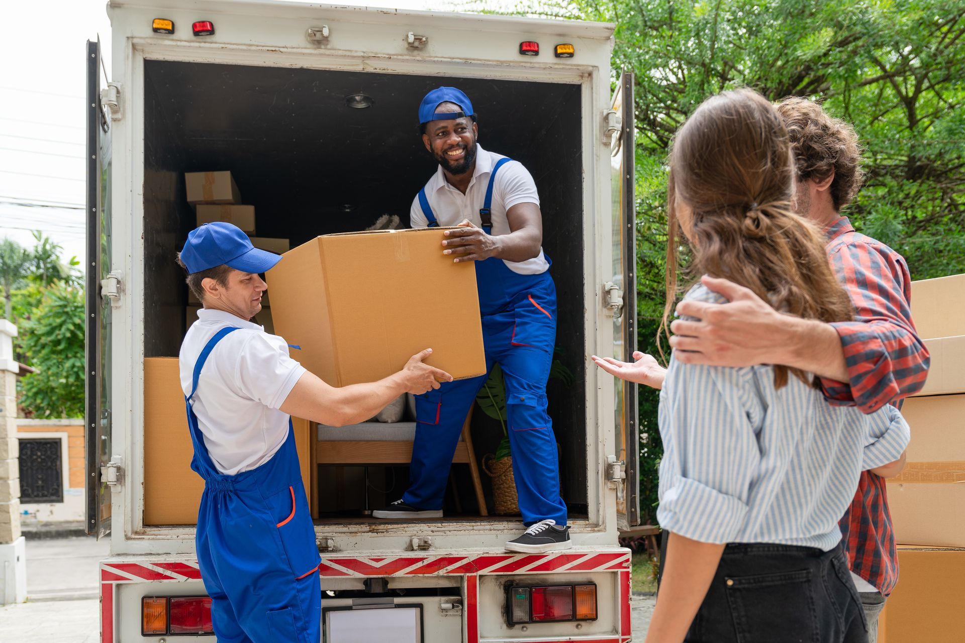 Two men are holding a moving box.