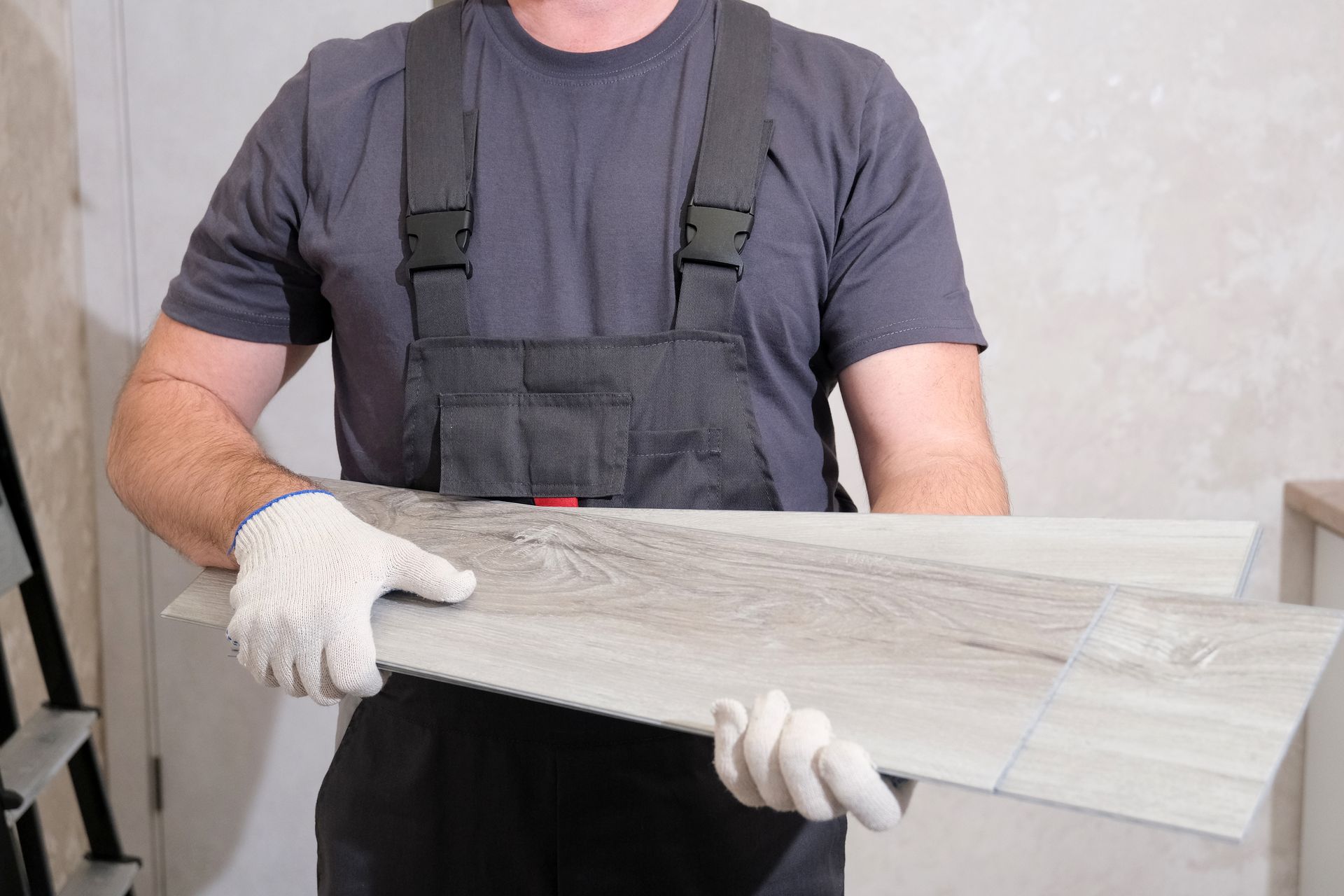 A worker holding LVP flooring during an LVP flooring installation near Myrtle Beach, SC. 