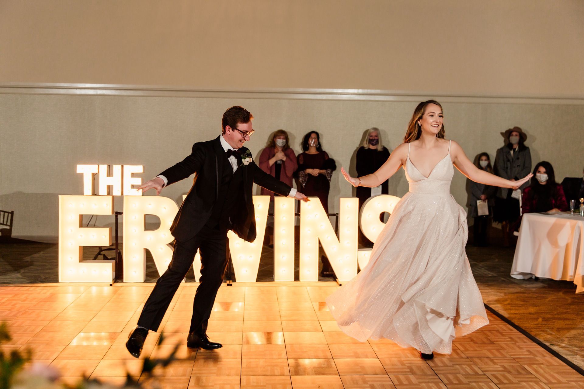 Couple dancing on a dance floor with a lit 