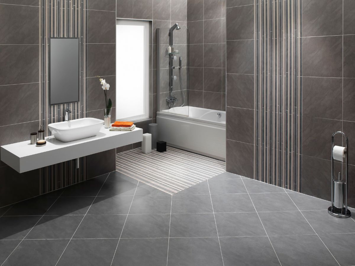 Modern gray bathroom with floating sink, bathtub, and patterned tile floor.