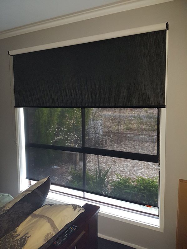 A Bedroom With A Bed And A Window With Black Blinds — Queanbeyan Carpets in Queanbeyan, NSW