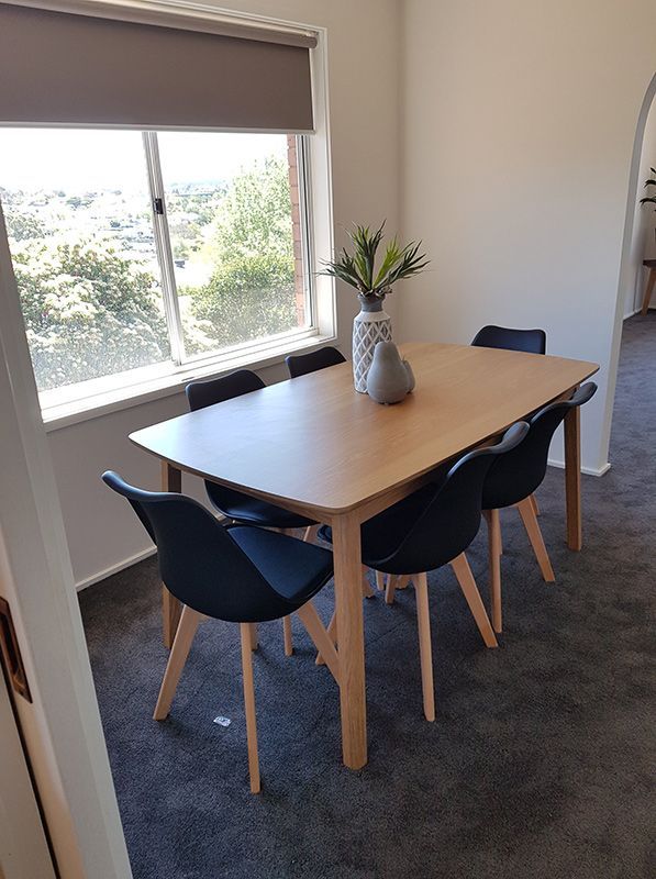 A Dining Room With Table, Chairs, And Black Carpet — Queanbeyan Carpets in Queanbeyan, NSW
