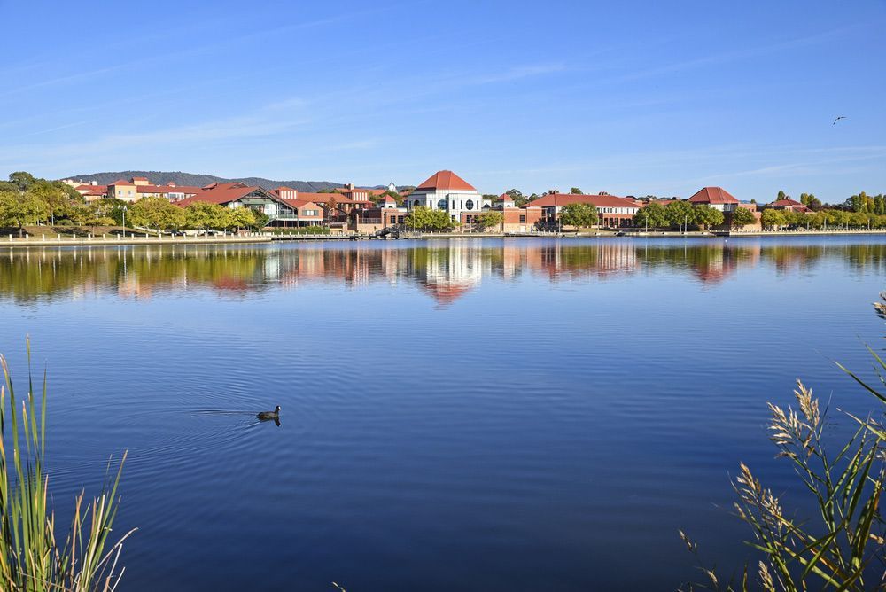 Early Morning View Of Tuggeranong City From The Other Side Of The Lake — Queanbeyan Carpets in Tuggeranong, NSW