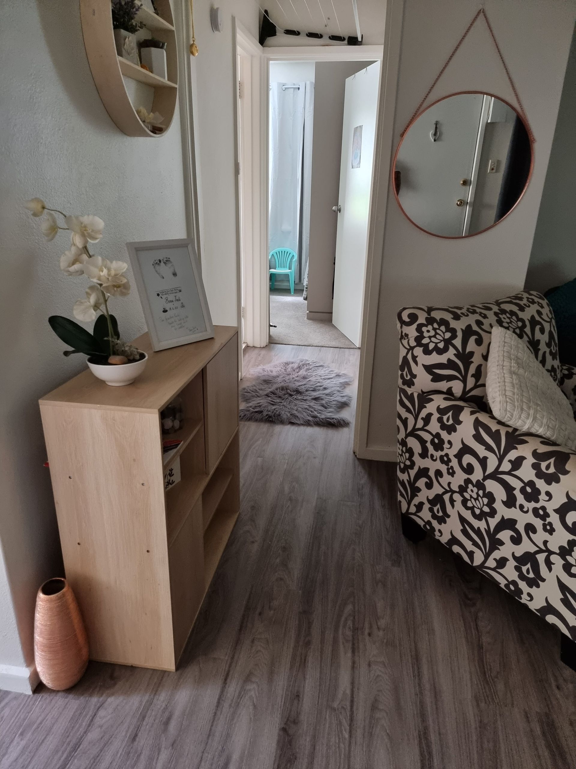 Hallway With Wood Console, Patterned Sofa, Round Mirror, and Open Doorway — Queanbeyan Carpets in Queanbeyan, NSW