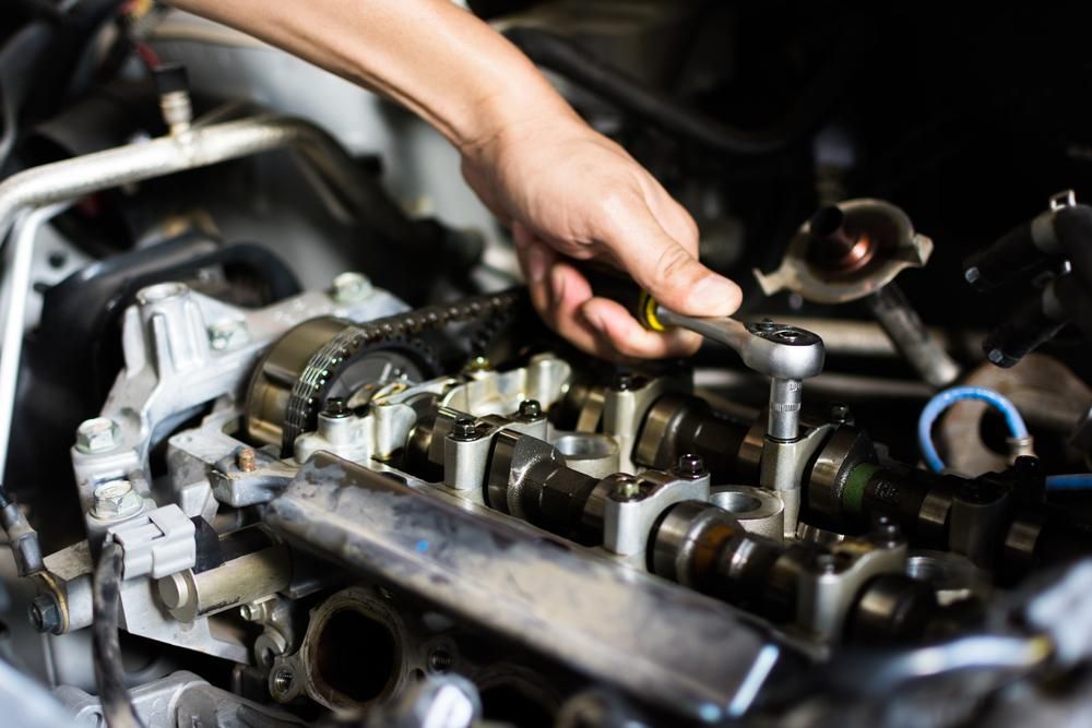 Mechanic Working on A Car Engine, Using a Wrench in A Close-Up Shot— Joy Hire Compressor Hire & Maintenance in Paget, QLD