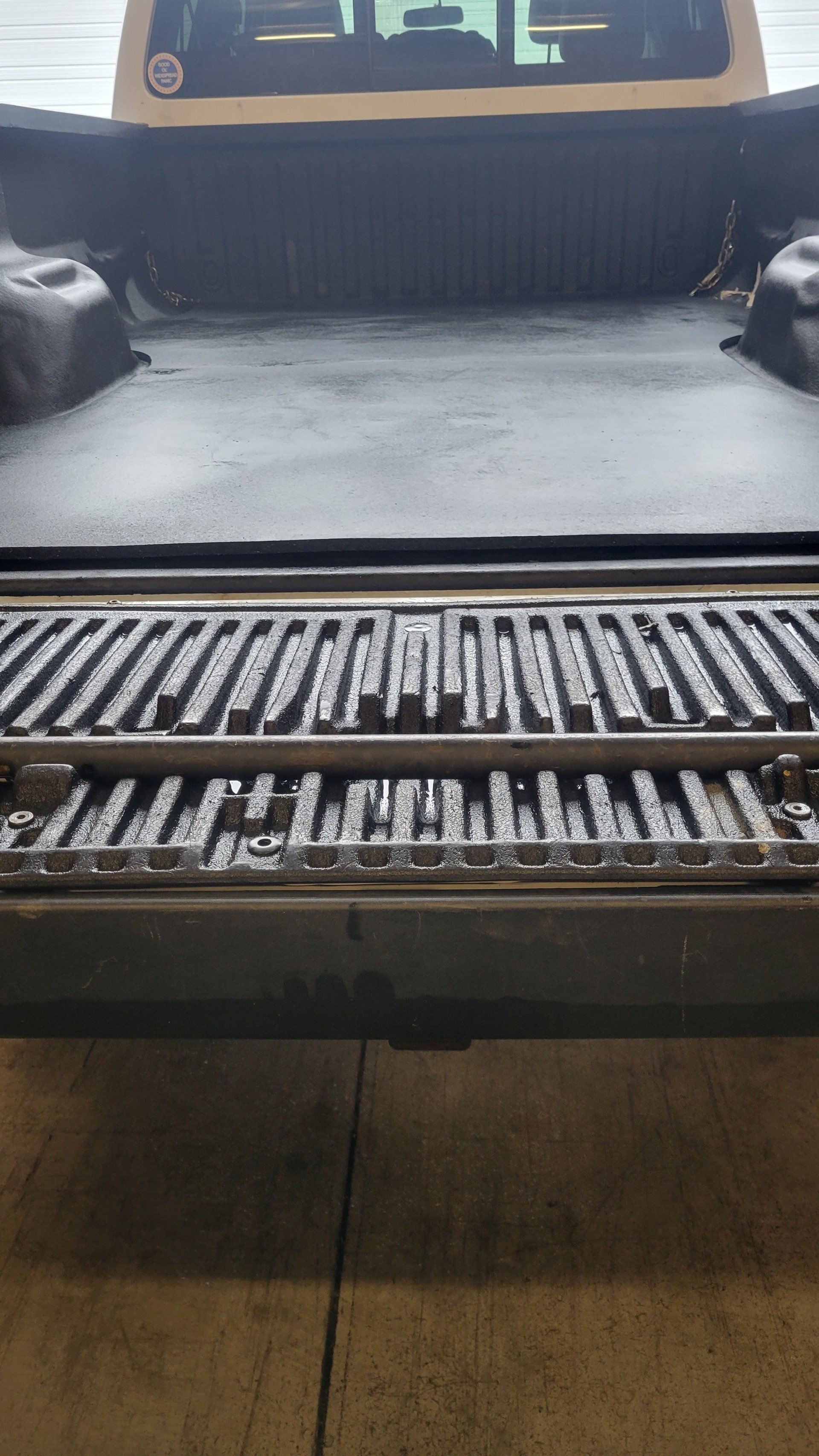 A close up of the back of a truck with the tailgate open.