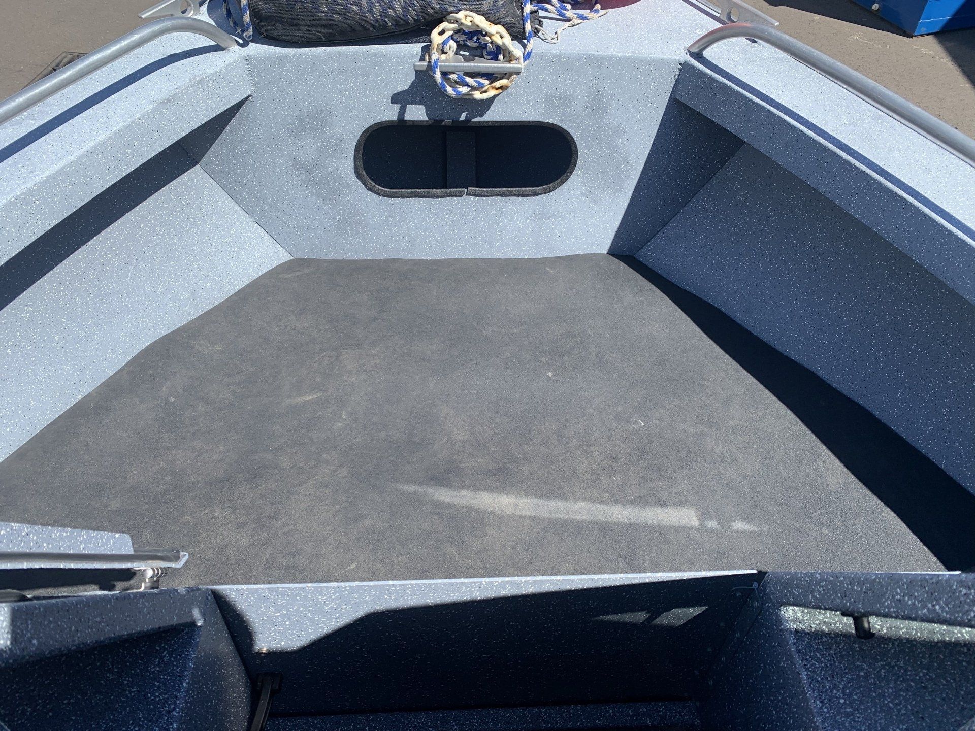 The front of a boat with a steering wheel on it