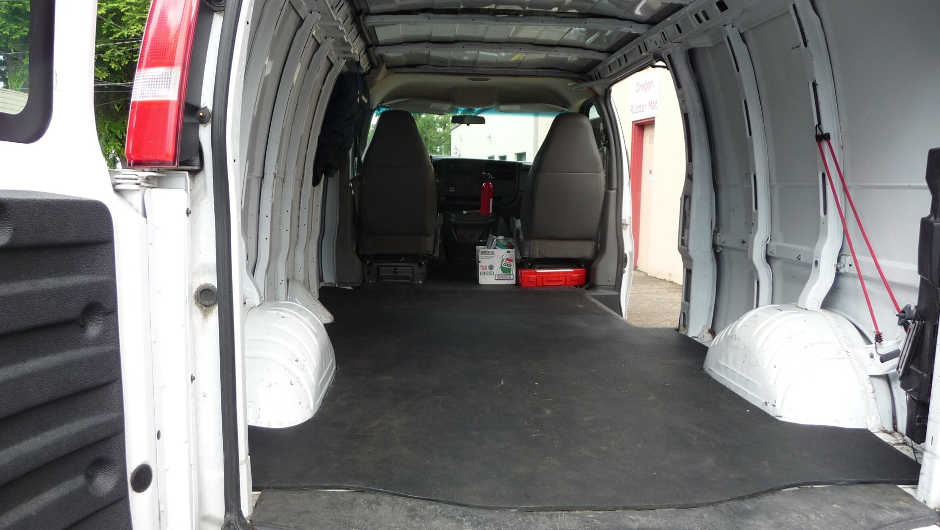 The inside of a white van with the door open
