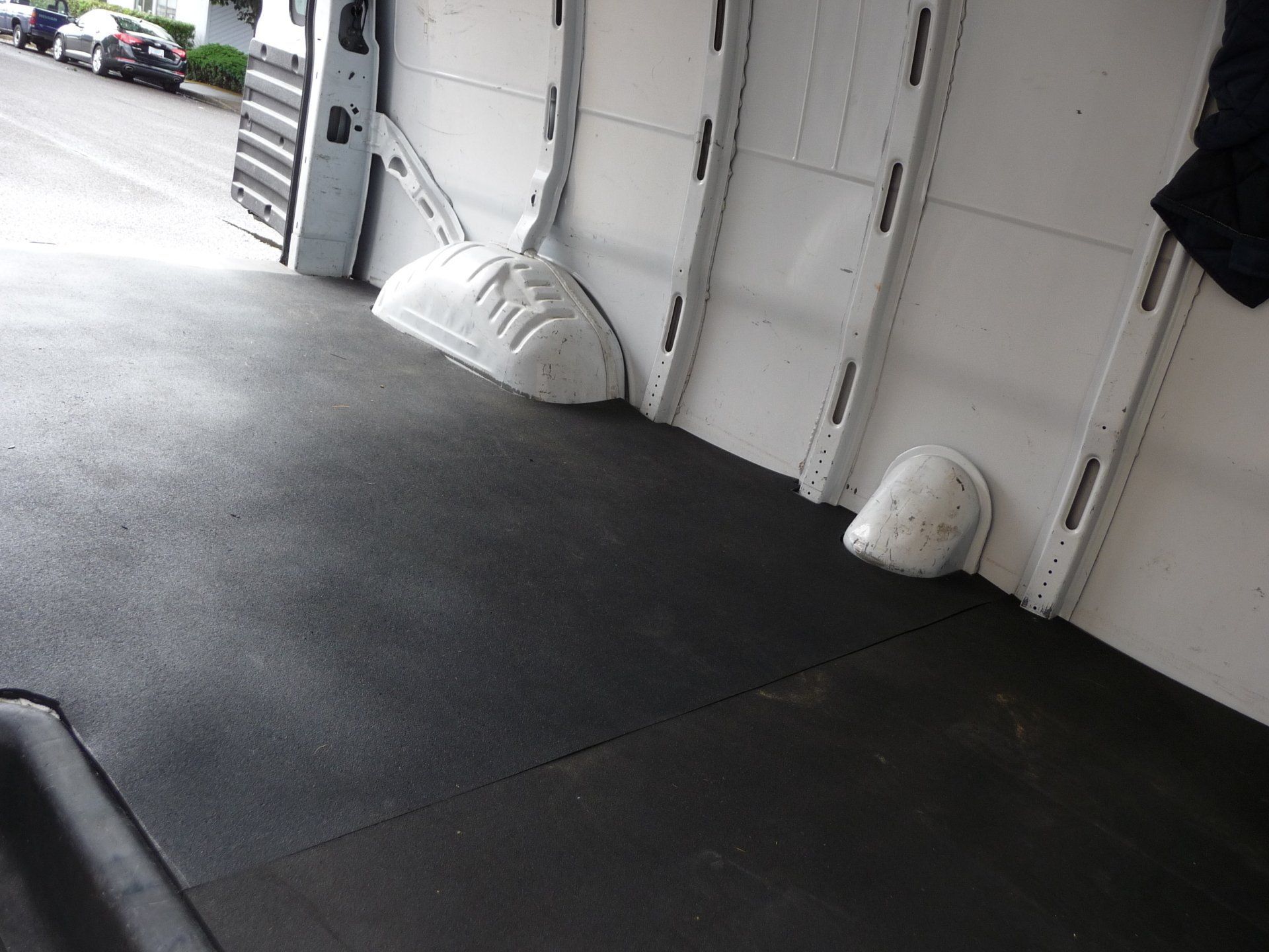 The inside of a white van with a black floor
