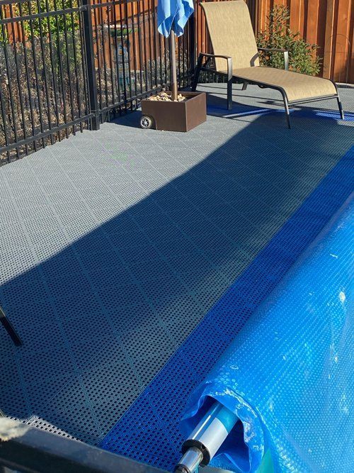 A swimming pool with a blue cover on it