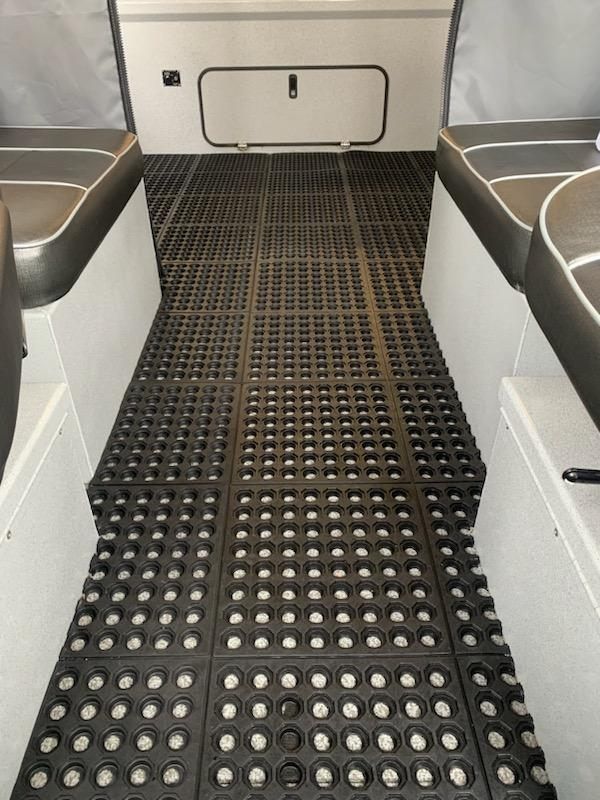 A black rubber floor with white dots on it