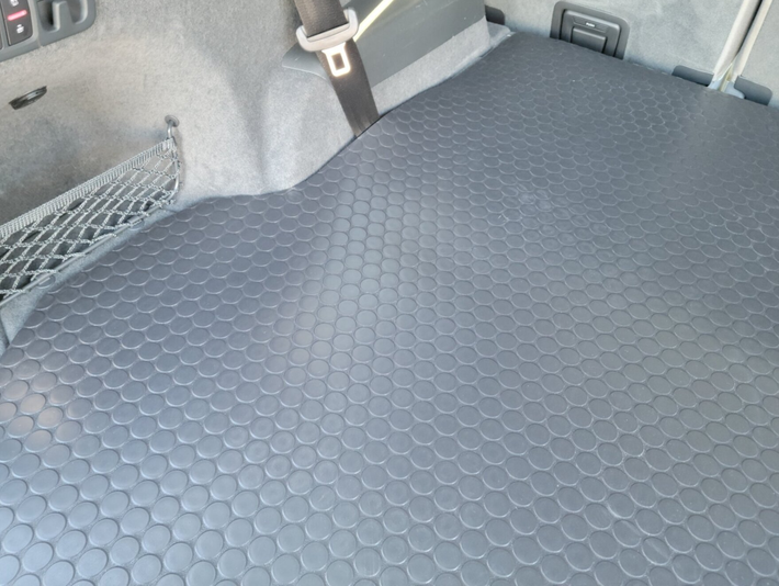 The back seat of a car with a seat belt on it