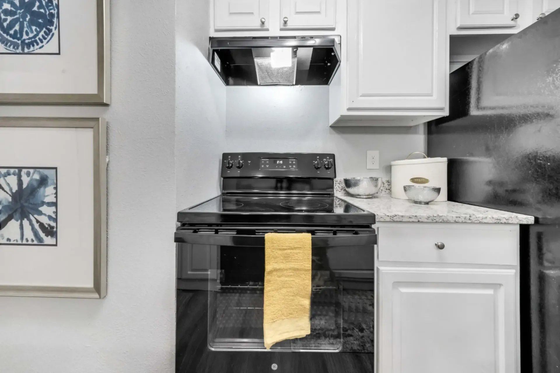 A kitchen with a stove and a towel in the oven.