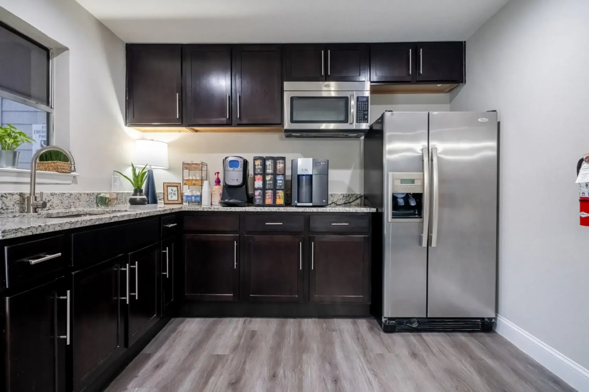 A kitchen with stainless steel appliances and wooden cabinets.