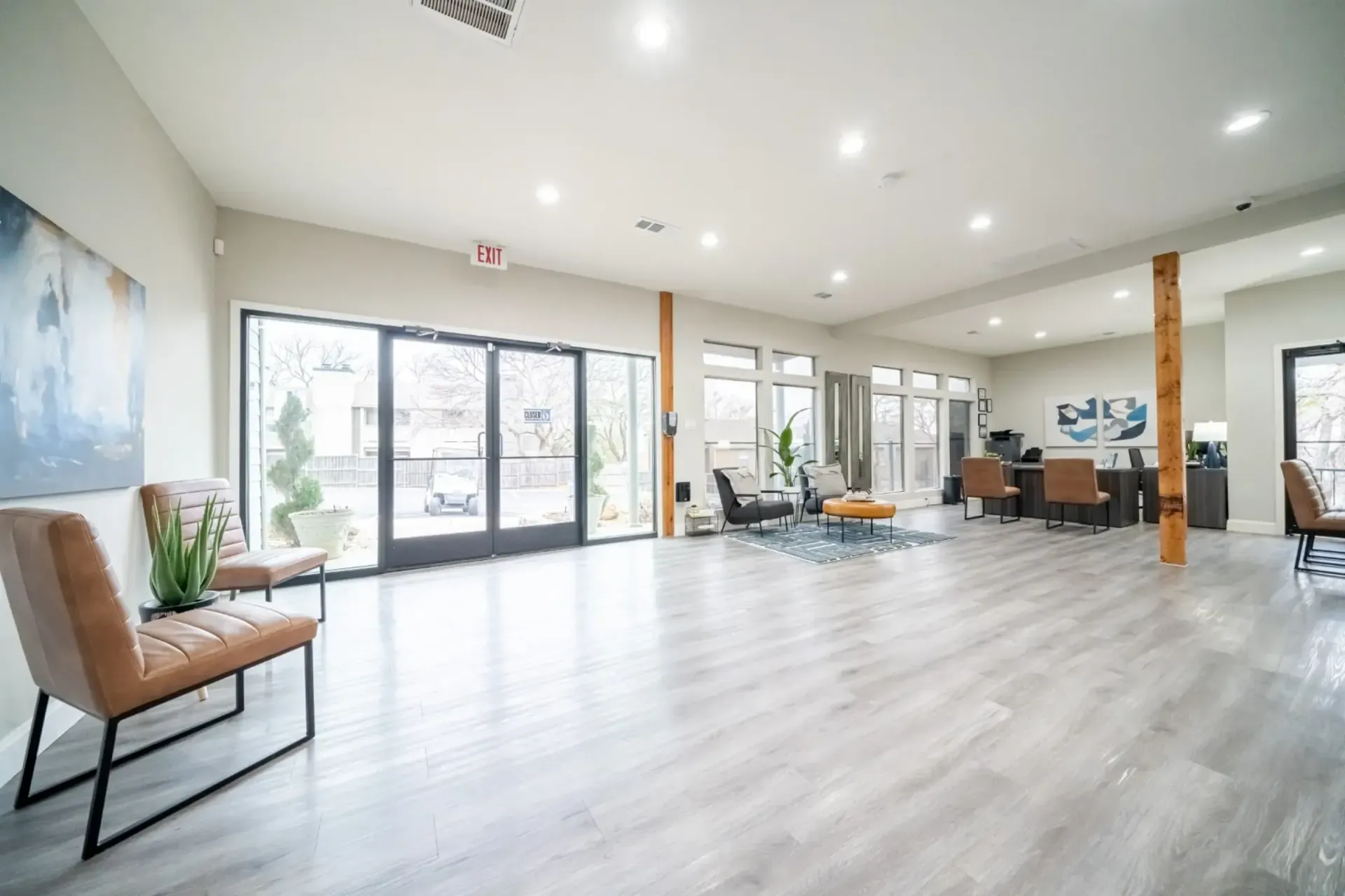 A large room with a lot of windows and chairs in it.
