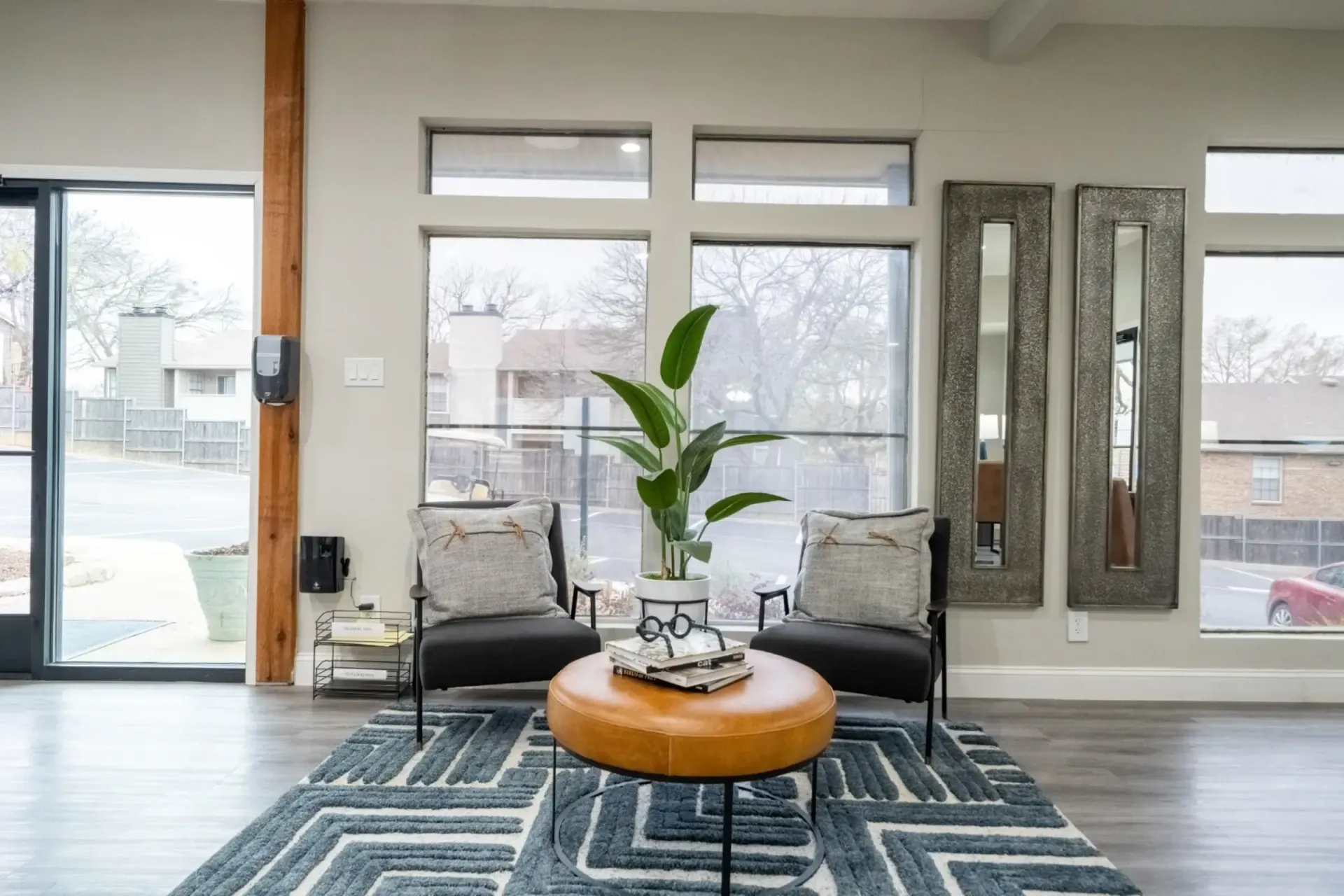 A living room with two chairs , a coffee table , and a rug.