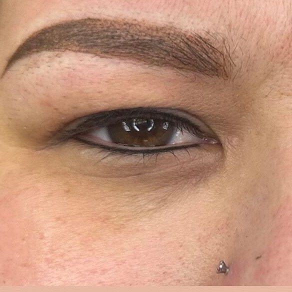 A close up of a woman 's eyes and eyebrows.