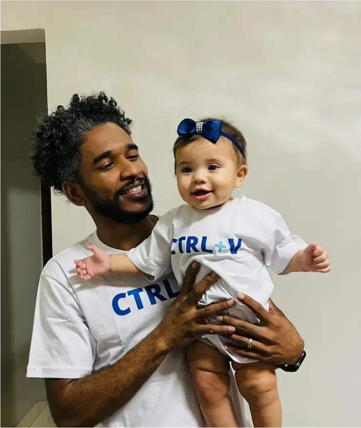 Man holding baby; both wear 