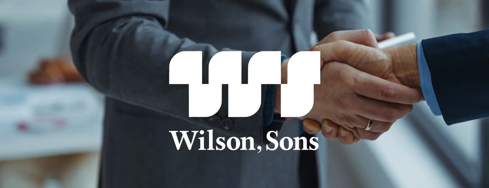 Two people shaking hands, Wilson, Sons logo in between.