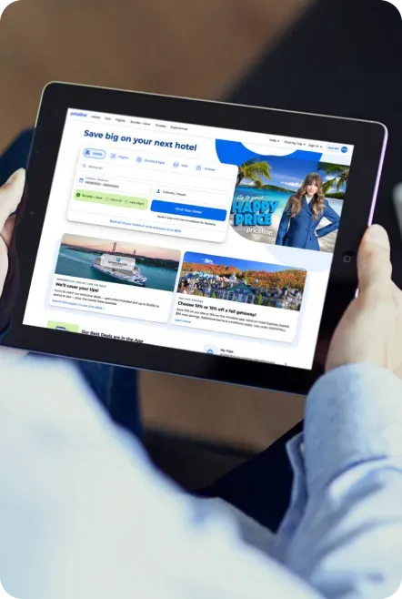 Person holding tablet displaying a travel website.