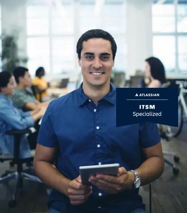 Man holding tablet, smiling in office; ITSM Specialized logo.