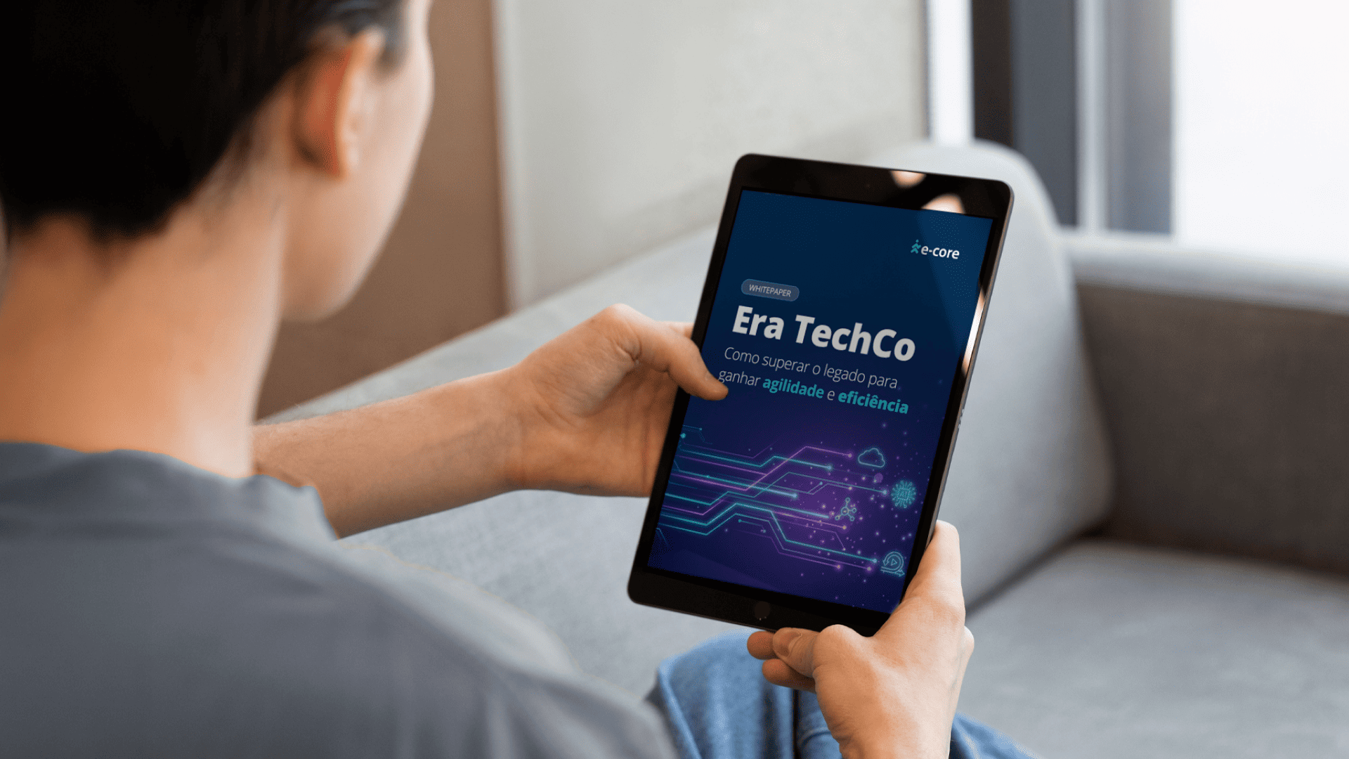 Person holding a tablet showing “Era TechCo” with a blue digital interface on screen