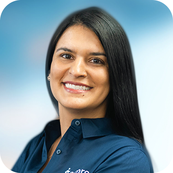 Smiling person with long dark hair in a navy shirt against a blue background