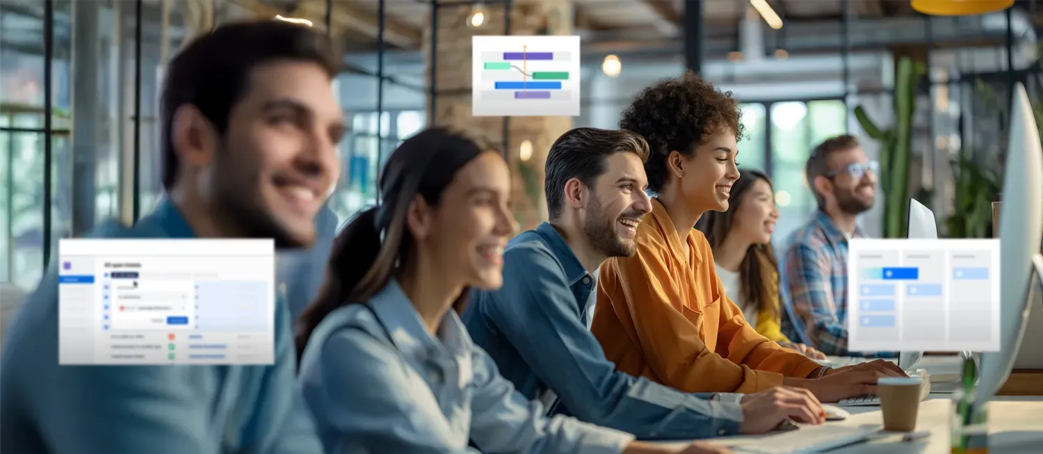 People working together in an office, looking at computer screens, some smiling.