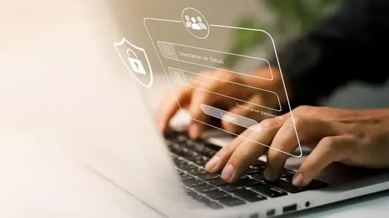 Person typing on a laptop with a digital login interface overlaid.