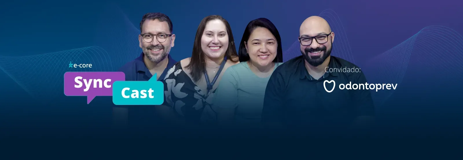 Four people smiling in front of a blue background with the words 