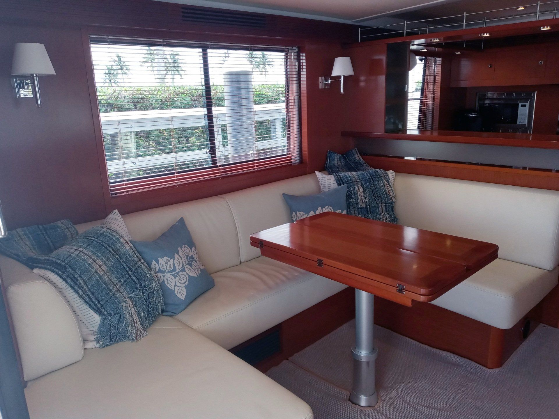 A living room on a boat with a table and a couch