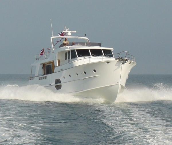 A large white boat is floating on top of a body of water