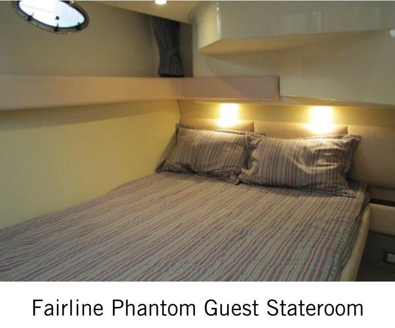 A picture of a bed on a boat that says fairline phantom guest stateroom