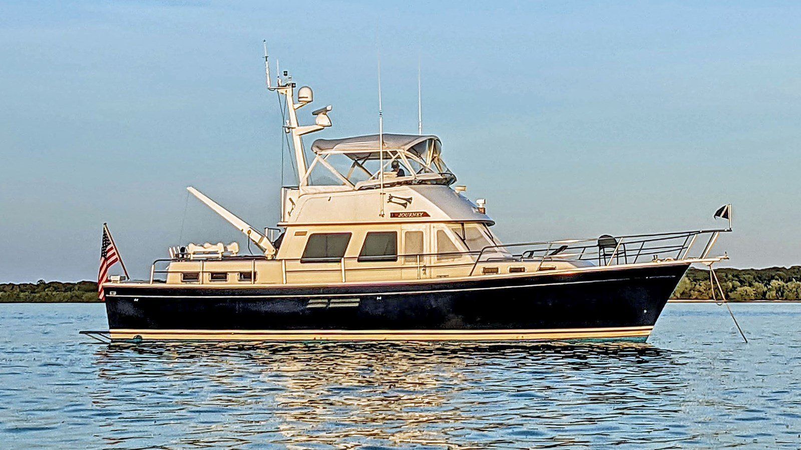 A large boat is floating on top of a body of water.
