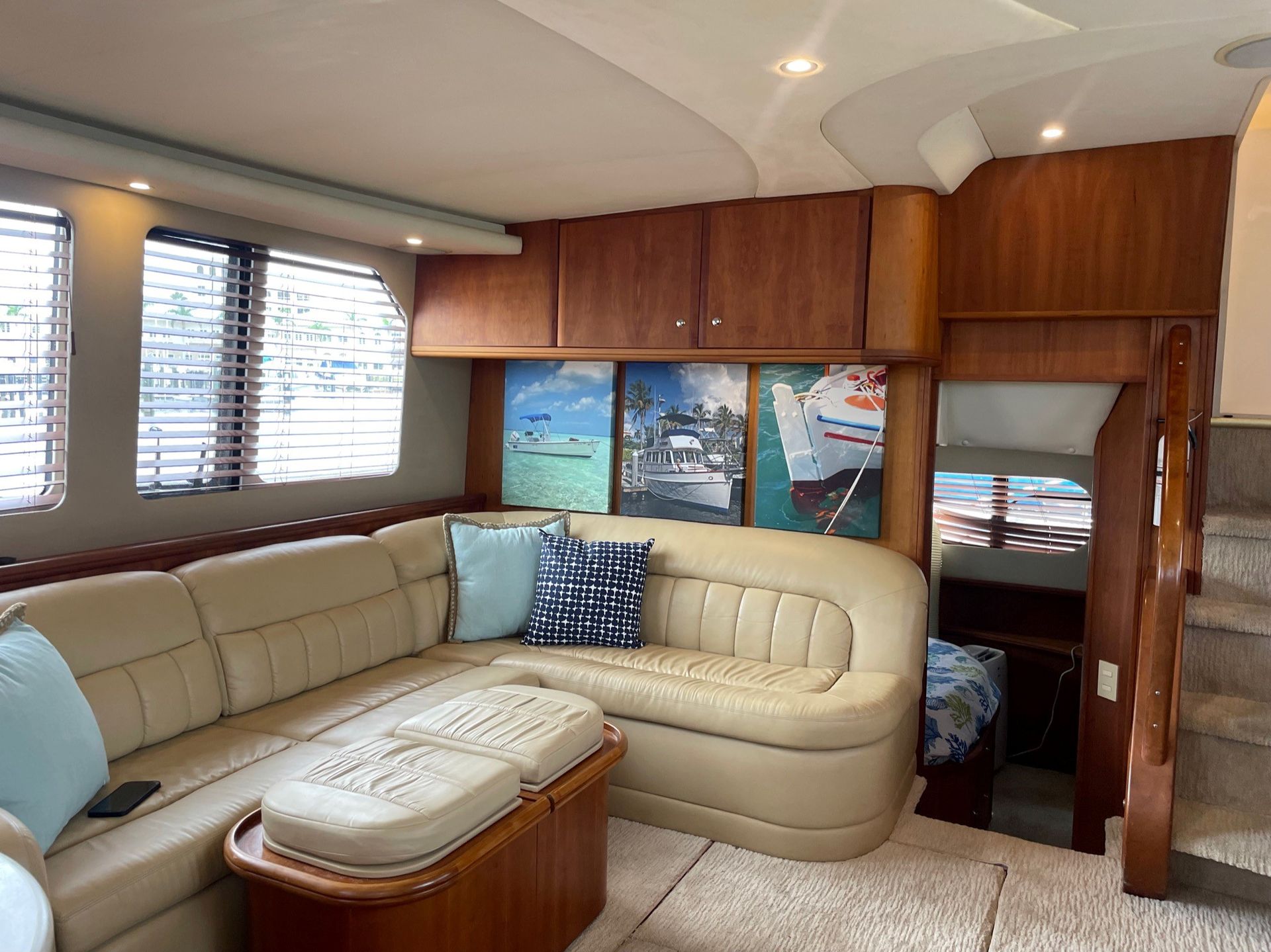 A living room on a boat with a couch and stairs.