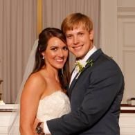 Smiling couple in formal wedding attire posing together indoors