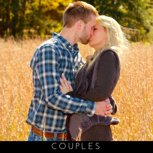 Couple embracing in a sunlit field of tall grass, with the word “COUPLES” below